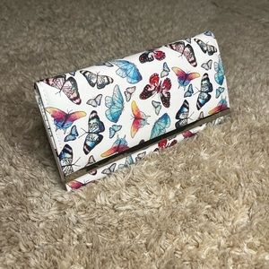 white clutch with colorful butterflies